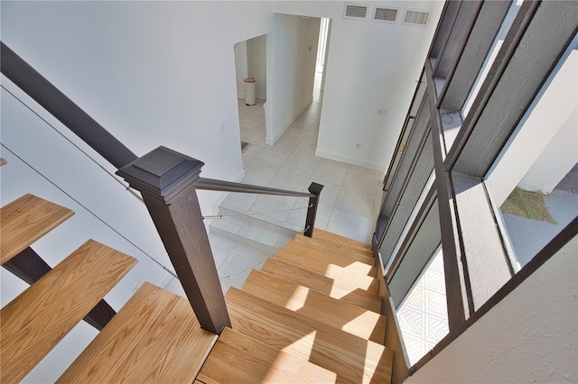 staircase featuring tile patterned flooring