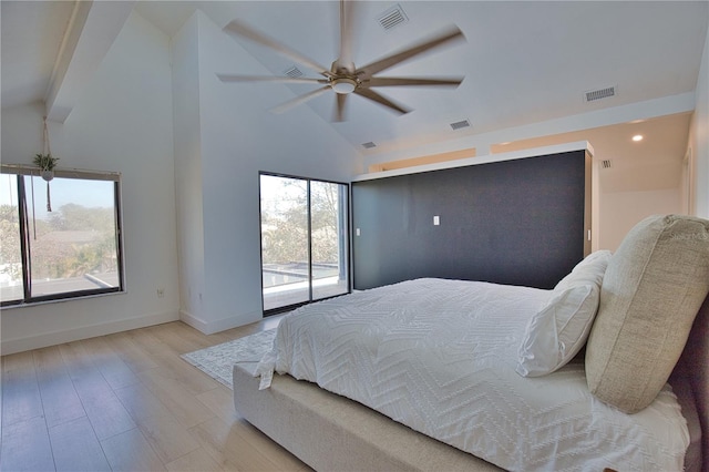 bedroom with high vaulted ceiling, light wood-type flooring, multiple windows, and access to outside