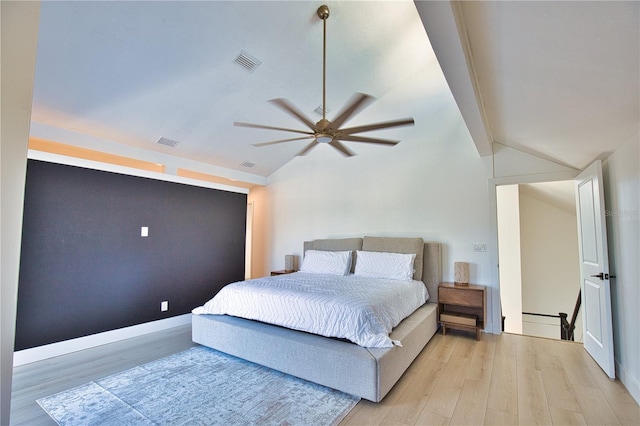 bedroom featuring ceiling fan, lofted ceiling, and light hardwood / wood-style floors