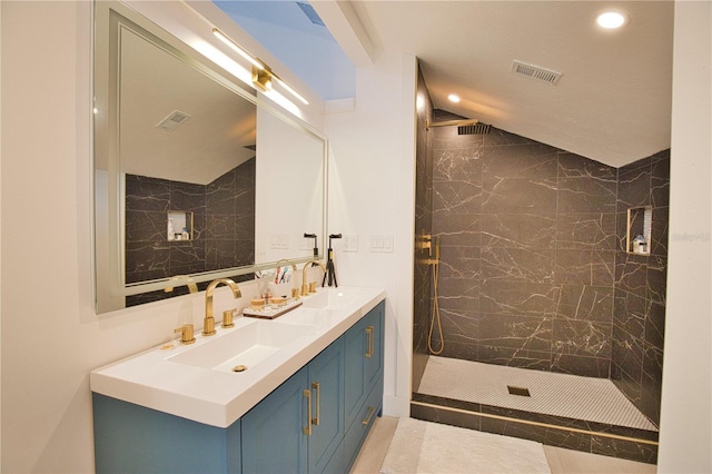 bathroom featuring vanity and tiled shower