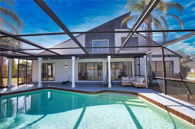 view of swimming pool with an outdoor living space, a lanai, and a patio area