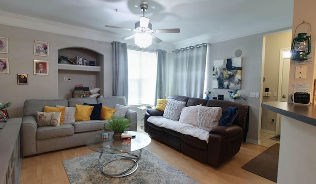 living room featuring crown molding, ceiling fan, and light hardwood / wood-style flooring