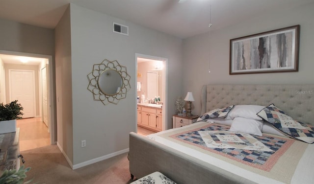 carpeted bedroom featuring ensuite bath