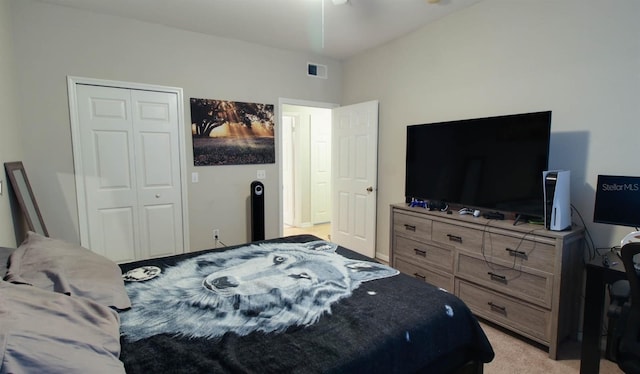 bedroom featuring light colored carpet and a closet