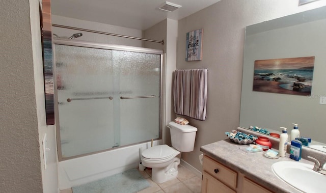 full bathroom featuring tile patterned flooring, vanity, shower / bath combination with glass door, and toilet