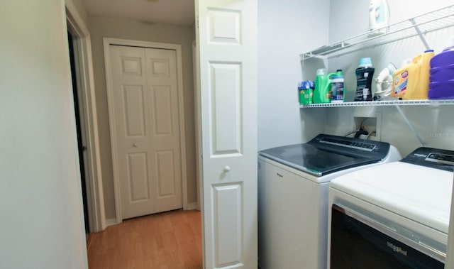 washroom featuring light hardwood / wood-style floors and washing machine and clothes dryer