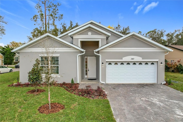 view of front of property featuring a garage and a front lawn