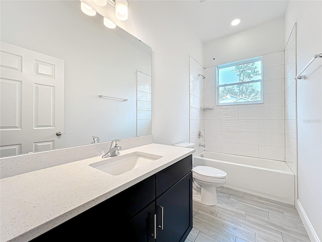 full bathroom with vanity, toilet, and tiled shower / bath combo