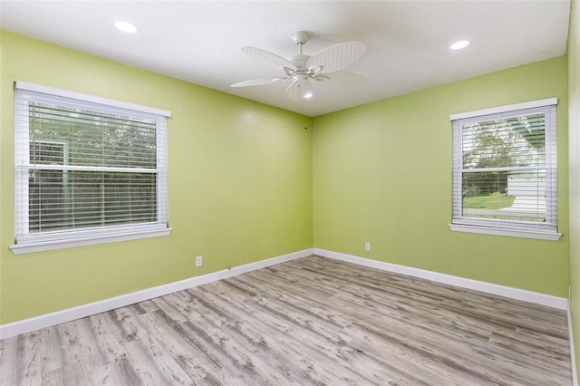 spare room featuring ceiling fan, baseboards, wood finished floors, and recessed lighting