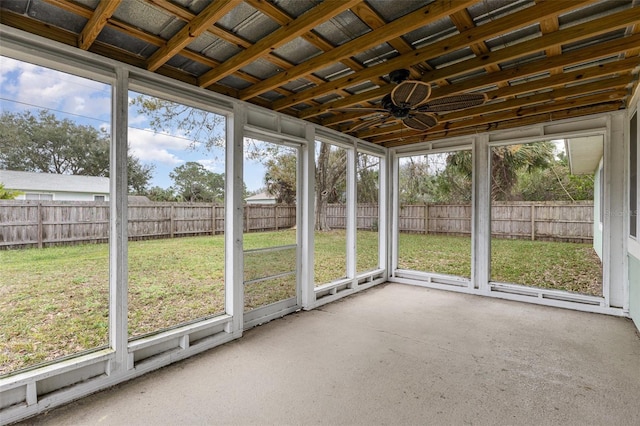 unfurnished sunroom featuring ceiling fan