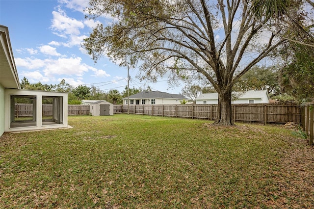 view of yard featuring a shed, an outdoor structure, and a fenced backyard