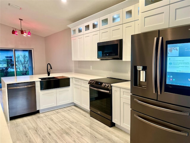 kitchen featuring appliances with stainless steel finishes, sink, and white cabinets