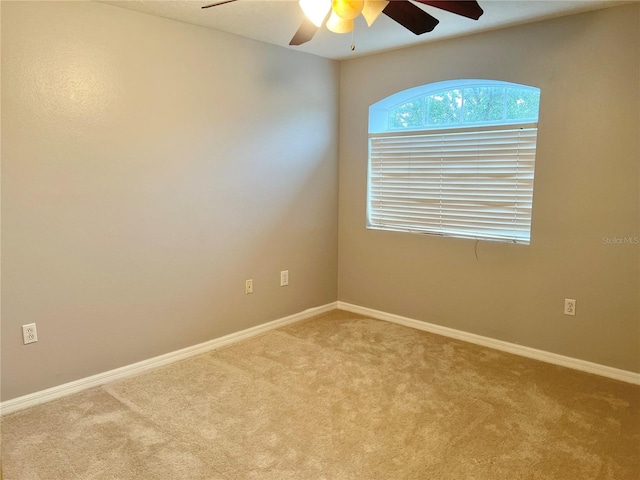 spare room with light carpet and ceiling fan