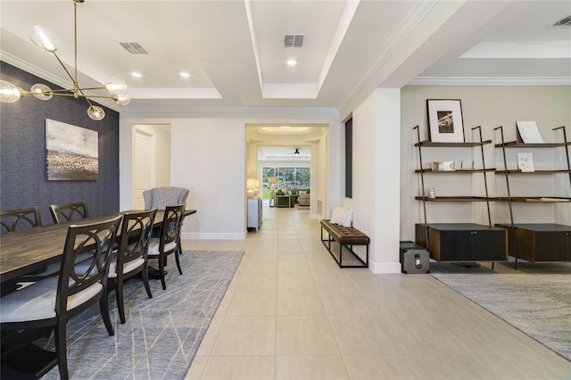 tiled dining room with crown molding, a notable chandelier, and a tray ceiling