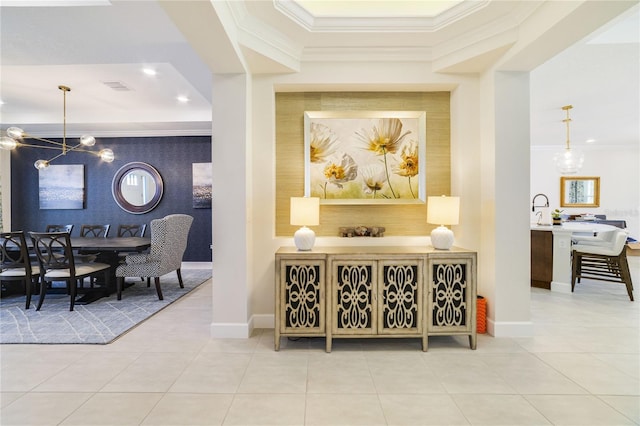 interior space with ornamental molding, sink, a chandelier, and tile patterned flooring