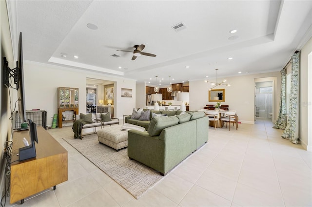 living room with ornamental molding, a raised ceiling, ceiling fan, and light tile patterned flooring