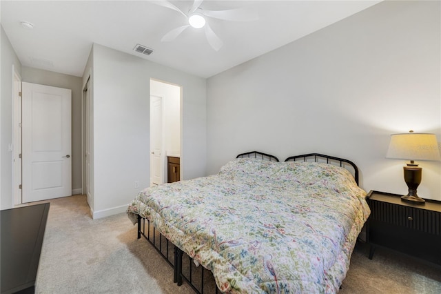 carpeted bedroom with ceiling fan and ensuite bathroom