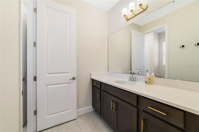 bathroom featuring vanity, tile patterned floors, and toilet