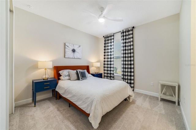 bedroom featuring light colored carpet and ceiling fan