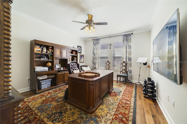 office space featuring ceiling fan, ornamental molding, light hardwood / wood-style flooring, and a textured ceiling