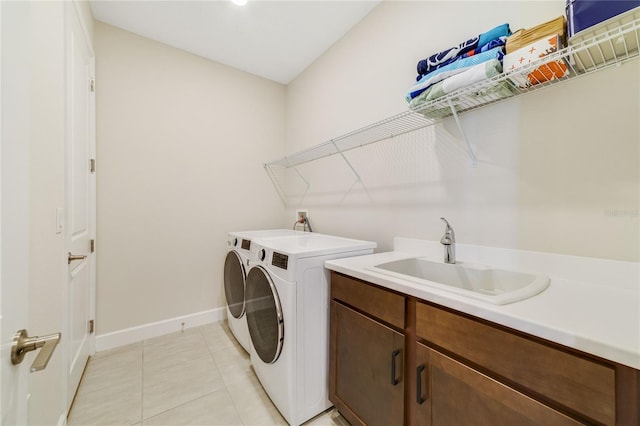 washroom with cabinets, light tile patterned flooring, sink, and independent washer and dryer