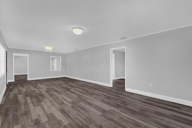 unfurnished room with dark wood-type flooring and crown molding