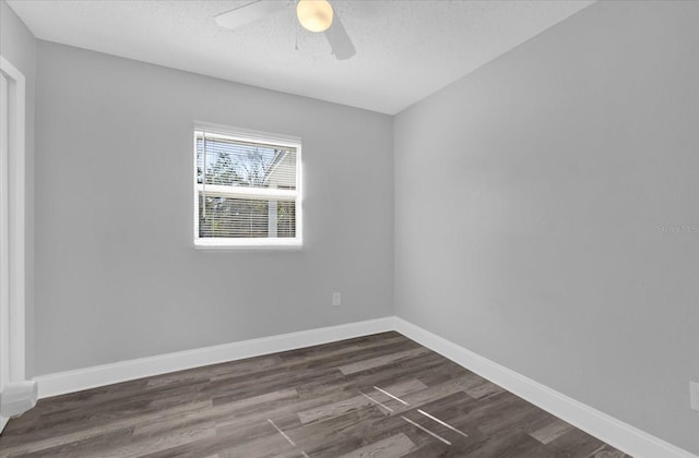 unfurnished room with dark wood-type flooring, ceiling fan, and a textured ceiling