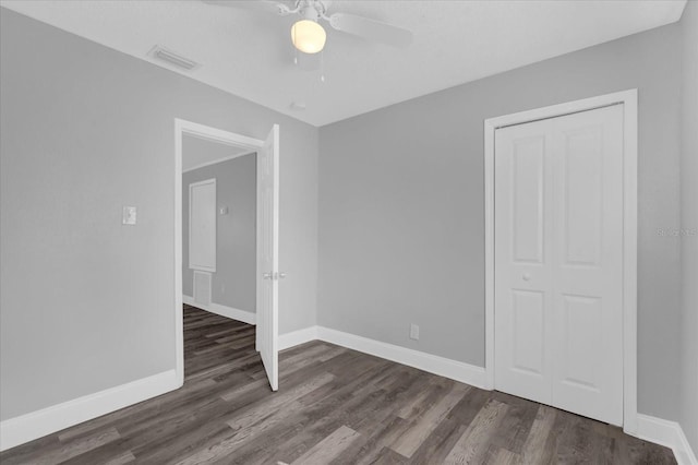 empty room with ceiling fan and dark hardwood / wood-style floors