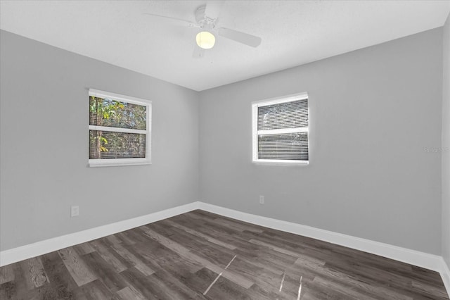 empty room with dark wood-type flooring, ceiling fan, and a textured ceiling