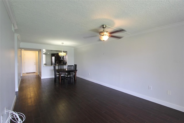 unfurnished dining area featuring dark wood-type flooring, crown molding, ceiling fan with notable chandelier, and a textured ceiling