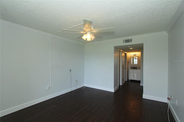 spare room featuring crown molding, dark wood-type flooring, a textured ceiling, and ceiling fan