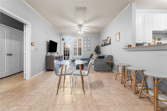 dining space featuring ornamental molding and ceiling fan