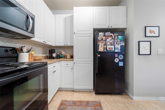 kitchen with light tile patterned floors, white cabinets, backsplash, and black appliances