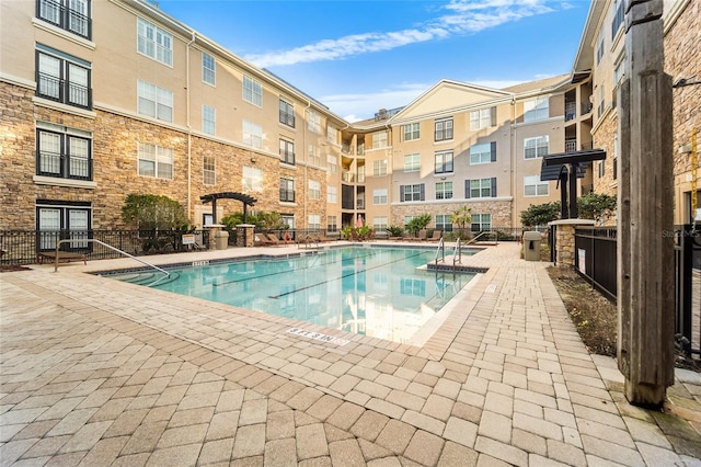 view of swimming pool featuring a patio and a pergola