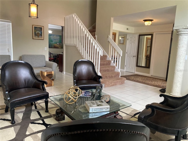 living area featuring stairway, baseboards, and tile patterned flooring