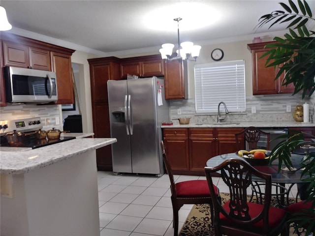 kitchen with light tile patterned floors, appliances with stainless steel finishes, crown molding, and a sink