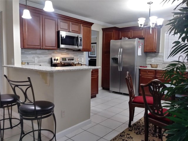 kitchen featuring a kitchen breakfast bar, appliances with stainless steel finishes, a peninsula, crown molding, and light tile patterned floors