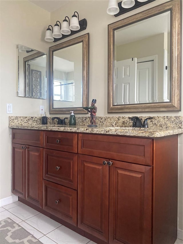 bathroom featuring tile patterned floors, double vanity, and a sink