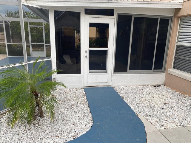 entrance to property with stucco siding