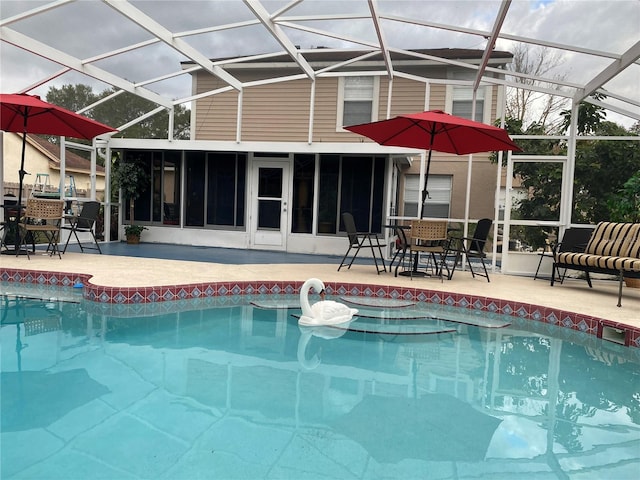 pool with a lanai and a patio area