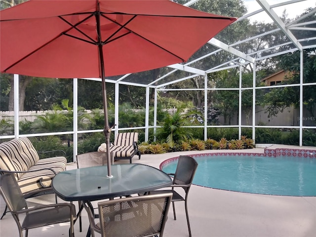 outdoor pool with outdoor dining space, a patio, and a lanai