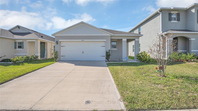 view of front of home with a garage and a front lawn