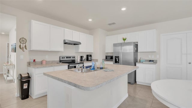 kitchen with sink, white cabinetry, a center island with sink, light tile patterned floors, and appliances with stainless steel finishes