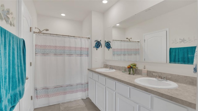 bathroom with vanity, curtained shower, and tile patterned floors