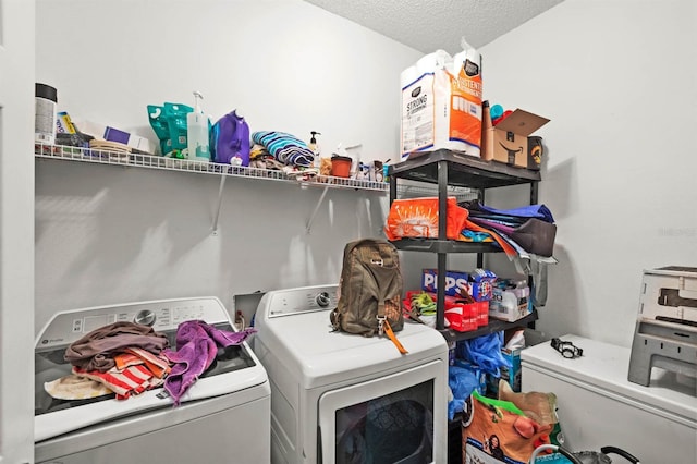 laundry room with washer and dryer and a textured ceiling