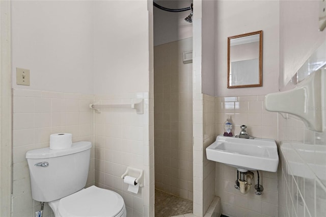 bathroom featuring tile walls, a shower, and toilet