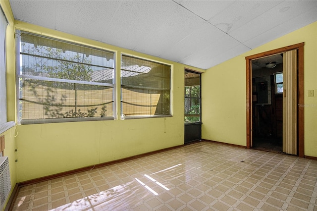 unfurnished sunroom featuring lofted ceiling
