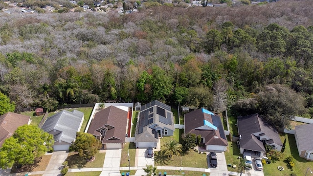 aerial view featuring a forest view and a residential view