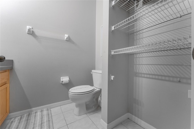 bathroom featuring tile patterned flooring, vanity, and toilet