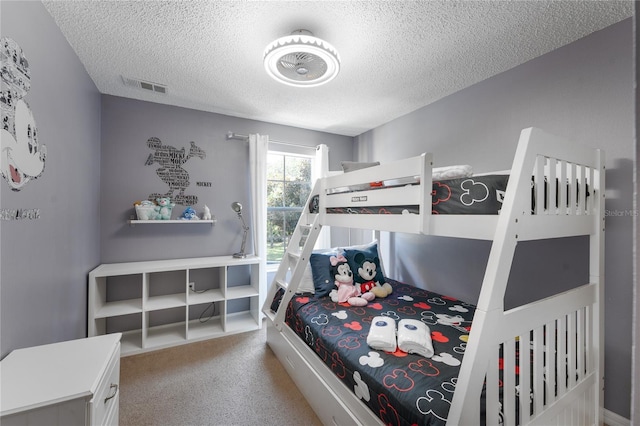 carpeted bedroom featuring a textured ceiling